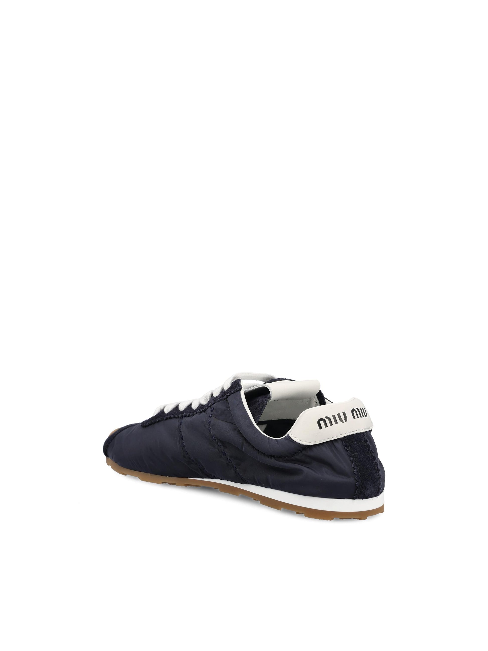 Sneakers realizzate in tessuto tecnico e pelle. 5E114E D7CF0008 MIU MIU 